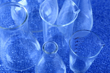 Different laboratory glassware on color background