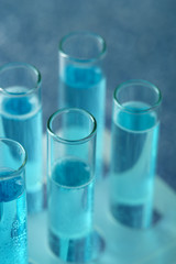 Test-tubes with liquid on color background