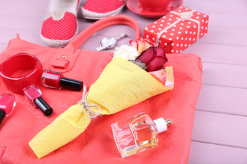 Women bag stuff on wooden background top view