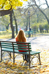 Lonely woman on bench in park