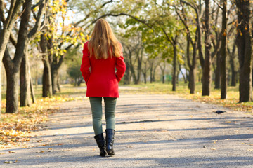 Lonely woman walking in park