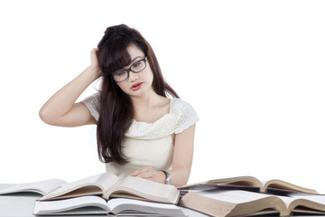 Confused student reading many books 2