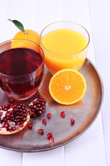 Glasses of fresh orange and pomegranate juice