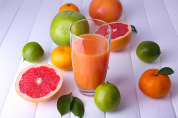 Juice and many citrus on table close-up