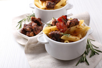 Tasty pasta with meat in ceramic pot