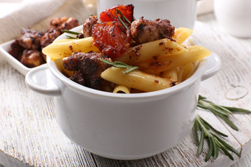 Tasty pasta with meat in ceramic pot