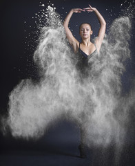 Obraz na płótnie Canvas Dancing woman and flying dust.