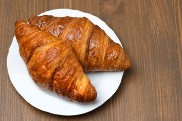 fresh croissants on a plate, top view
