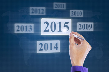 Hand with stylus selects number 2015
