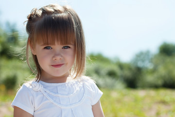 Portrait of lovely little girl in park