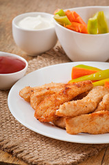 Chicken nuggets with sauce and vegetables