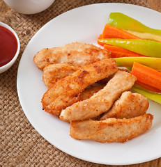 Chicken nuggets with sauce and vegetables