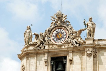 Sculptures and clock on the facade of Vatican city works