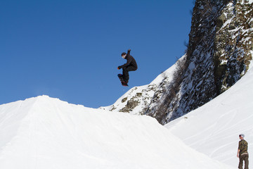Naklejka na ściany i meble Snowboarder jumps in Snow Park, ski resort