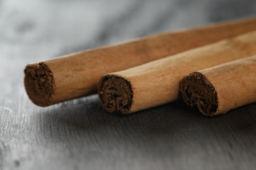 true cinnamon sticks on wooden table