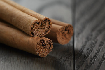 true cinnamon sticks on wooden table