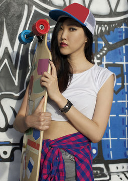 Stylish girl with skateboard