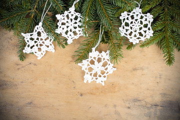 Christmas background with branches of fir and crochet stars