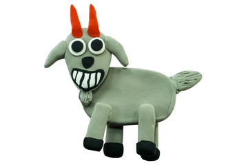 Smiling goat made from plasticine on white