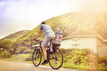 Father and daughter on bicycle in park