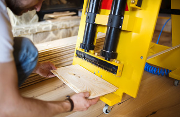 Handyman measuring wooden floor