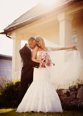 Fototapeta premium Bride and groom by the old house