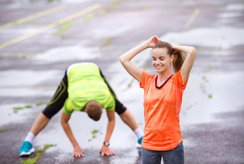 Couple stretching in rainy weather