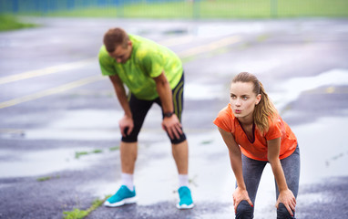 Couple stretching in rainy weather
