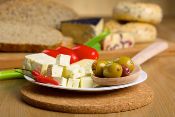 Feta cheese, olives and tomatos on a plate