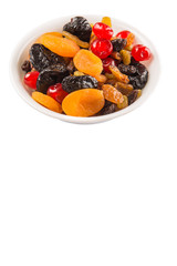 Mix variety of dried fruit in white bowl over white background