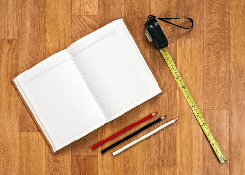Blank Notepad with Office Supplies on Wooden Table.