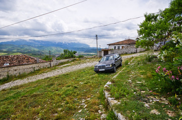 Typical car on old courtyard in Albania, Berat