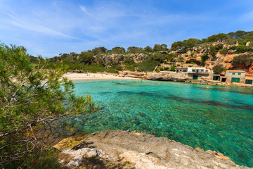 Fototapeta na wymiar Rocks bay beach azure sea water, Cala Llombards, Majorca island