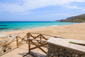 Walkway to sand beach in Cala Mesquida bay, Majorca island