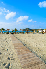 Wooden walkway to Porto Giunco beach, Sardinia island, Italy