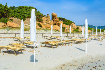 Sunbeds with umbrellas on Porto Giunco beach, Sardinia island