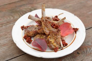 Grilled rack of lamb garnished with autumn leaves