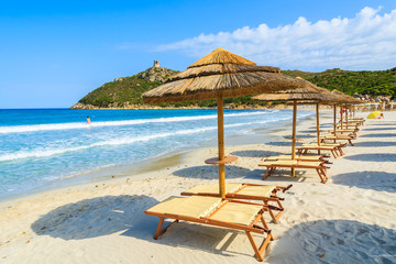Villasimius beach with sunchairs and umbrellas, Sardinia island