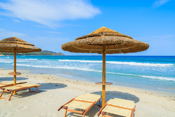Villasimius beach with sunchairs and umbrellas, Sardinia island