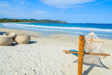 Hammock and chairs on sandy Porto Giunco beach, Sardinia island