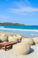 Fototapeta na wymiar Beach bar chairs on sandy Porto Giunco beach, Sardinia island