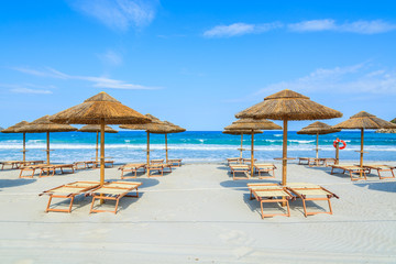 Villasimius beach with sunchairs and umbrellas, Sardinia island