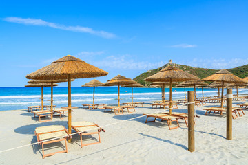 Villasimius beach with sunchairs and umbrellas, Sardinia island