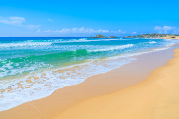 Sea waves on Chia beach and turquoise sea water, Sardinia island