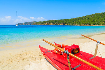 Red boat on beautiful beach of Teuleda, Sardinia island, Italy