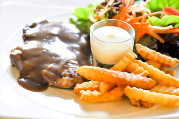 pork steak, French fries  and salad
