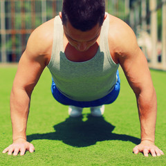 Sport, fitness and workout concept - Sportsman doing push-ups ex