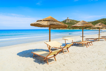Sunbeds with umbrellas on Porto Giunco beach, Sardinia island