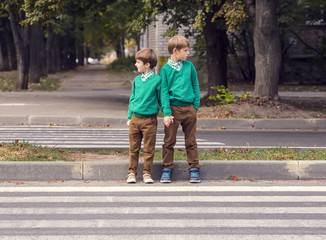 Fototapeta premium Portrait of a boy on a background of green nature