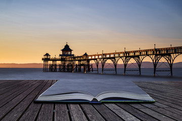 Beautiful long exposure sunset over ocean with pier silhouette c